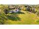 Aerial view of the home highlighting the screened porch, landscaping, and expansive yard at 1601 Dairyland Rd, Chapel Hill, NC 27516