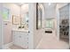 Bathroom with a white vanity, ample storage, and a doorway leading to the bedroom at 1601 Dairyland Rd, Chapel Hill, NC 27516