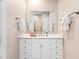Bathroom featuring a bright vanity area with a large mirror, fresh flowers and modern fixtures at 1601 Dairyland Rd, Chapel Hill, NC 27516