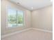Bright bedroom has neutral walls, plush carpet, and large window at 1601 Dairyland Rd, Chapel Hill, NC 27516