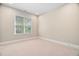 Bright bedroom has neutral walls, plush carpet, and large window at 1601 Dairyland Rd, Chapel Hill, NC 27516