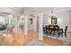 Spacious dining room featuring elegant columns, hardwood floors, and a stylish chandelier, perfect for gatherings at 1601 Dairyland Rd, Chapel Hill, NC 27516