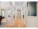 Elegant hallway with hardwood floors, decorative columns, and seamless flow between living spaces, perfect for entertaining at 1601 Dairyland Rd, Chapel Hill, NC 27516