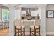 Kitchen featuring breakfast bar, white cabinetry, and stainless steel appliances at 1601 Dairyland Rd, Chapel Hill, NC 27516