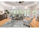 Sunlit living room featuring hardwood floors, a ceiling fan, and stylish gray decor at 1601 Dairyland Rd, Chapel Hill, NC 27516