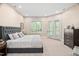 Bright bedroom featuring a large bed, neutral color palette, and access to a private balcony with outdoor views at 1601 Dairyland Rd, Chapel Hill, NC 27516