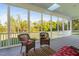 Spacious screened porch featuring stylish outdoor seating and lush greenery at 1601 Dairyland Rd, Chapel Hill, NC 27516