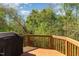 Exterior view of wooden deck overlooking lush greenery and blue sky background at 162 Grey Elm Trl, Durham, NC 27713