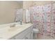 Bright bathroom with a vanity, large mirror, and floral shower curtain at 162 Grey Elm Trl, Durham, NC 27713