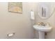 Stylish powder room with pedestal sink, elegant fixtures, and tasteful decor, offering a touch of sophistication at 162 Grey Elm Trl, Durham, NC 27713