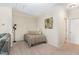 Cozy bedroom features neutral decor and is well-lit with a nearby hall door at 162 Grey Elm Trl, Durham, NC 27713