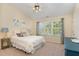 Cozy bedroom featuring a ceiling fan and large windows with curtains overlooking natural scenery at 162 Grey Elm Trl, Durham, NC 27713