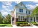 Charming two-story townhome with manicured landscaping and inviting entrance, showcasing the home's curb appeal at 162 Grey Elm Trl, Durham, NC 27713