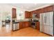 Modern kitchen with stainless steel appliances, granite countertops, and rich wood cabinetry, ideal for cooking and entertaining at 162 Grey Elm Trl, Durham, NC 27713