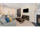 Cozy living room with comfortable seating, fireplace, and entertainment center at 162 Grey Elm Trl, Durham, NC 27713