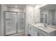 This bathroom features a shower with glass doors, double sinks and a large mirror at 189 Calebs Corner Pl, Spring Lake, NC 28390