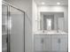 This bathroom features a glass shower, double sinks and a large mirror at 189 Calebs Corner Pl, Spring Lake, NC 28390