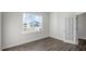 Well-lit bedroom featuring wood-look floors and a door leading to another room at 189 Calebs Corner Pl, Spring Lake, NC 28390
