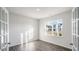 Sunlit bedroom with wood-look floors and a large window overlooking the neighborhood at 189 Calebs Corner Pl, Spring Lake, NC 28390