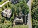 Bird's-eye view of a well-kept neighborhood highlighting the tree coverage, lawns, and a paved street at 2 Piney Ridge Ct, Durham, NC 27712