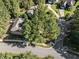 Aerial view of a suburban home with a trampoline in the backyard and mature trees on a well manicured lot at 2 Piney Ridge Ct, Durham, NC 27712