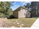 Back exterior features a deck with stairs, lush green lawn, and beautiful siding on a sunny day at 2 Piney Ridge Ct, Durham, NC 27712