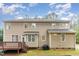Back exterior features a deck with stairs, lush green lawn, and beautiful siding on a sunny day at 2 Piney Ridge Ct, Durham, NC 27712