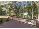 Spacious deck overlooking a wooded backyard with a playground, perfect for Gathering entertainment at 2 Piney Ridge Ct, Durham, NC 27712