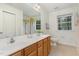 Large bathroom with double vanity sinks, mirrors, and decor at 2 Piney Ridge Ct, Durham, NC 27712