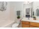Bright bathroom featuring tub/shower, vanity, decorative plant and neutral accents at 2 Piney Ridge Ct, Durham, NC 27712