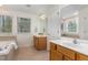Spacious bathroom with large windows, bathtub, and double vanity at 2 Piney Ridge Ct, Durham, NC 27712
