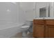 Well-lit bathroom with tub and shower combination and wood-finished vanity at 2 Piney Ridge Ct, Durham, NC 27712