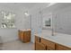 Bright bathroom with double vanities, a soaking tub, and a window offering natural light at 2 Piney Ridge Ct, Durham, NC 27712