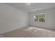 Empty bedroom with neutral carpet and a window offering natural light at 2 Piney Ridge Ct, Durham, NC 27712