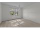 Empty bedroom with neutral carpet, a window and a decorative chandelier at 2 Piney Ridge Ct, Durham, NC 27712