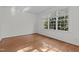 Bright, empty bedroom with hardwood floors and large window, ready for personalization at 2 Piney Ridge Ct, Durham, NC 27712