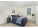 Cozy bedroom with neutral colors, a plush bed, and ample natural light at 2 Piney Ridge Ct, Durham, NC 27712
