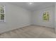 Minimalist bedroom with carpet, two windows, and neutral paint at 2 Piney Ridge Ct, Durham, NC 27712