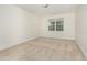 Empty bedroom with neutral carpet and a window offering natural light at 2 Piney Ridge Ct, Durham, NC 27712
