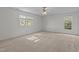 Sunlit bedroom with neutral walls, carpet, and windows with wooded view at 2 Piney Ridge Ct, Durham, NC 27712