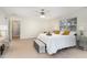 Spacious bedroom featuring fan, natural light, neutral walls and carpet at 2 Piney Ridge Ct, Durham, NC 27712