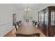 Formal dining room featuring hardwood floors, chandelier, and large wooden china cabinet at 2 Piney Ridge Ct, Durham, NC 27712