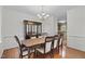 Formal dining room with hardwood floors, elegant chandelier, and stylish furniture at 2 Piney Ridge Ct, Durham, NC 27712