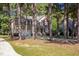 Two-story house featuring a brick facade, front porch, and a two-car garage surrounded by mature trees at 2 Piney Ridge Ct, Durham, NC 27712