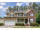 Charming two-story home with a combination of brick and siding and an attached garage at 2 Piney Ridge Ct, Durham, NC 27712