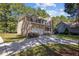 Spacious two-story home with a two-car garage, a front porch, mature trees, and a concrete driveway at 2 Piney Ridge Ct, Durham, NC 27712