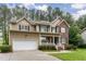 Charming two-story home with a brick and siding exterior, attached garage, and manicured landscaping at 2 Piney Ridge Ct, Durham, NC 27712
