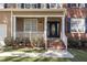 Inviting front porch with brick steps, white railings, and well-maintained landscaping at 2 Piney Ridge Ct, Durham, NC 27712