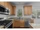 Updated kitchen with stainless steel appliances, granite countertops, and ample cabinet space at 2 Piney Ridge Ct, Durham, NC 27712