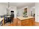 Open kitchen with granite island flowing to dining and living areas at 2 Piney Ridge Ct, Durham, NC 27712